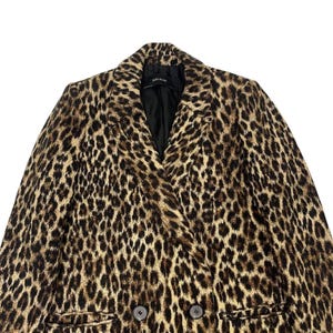 May include: A double-breasted leopard print coat with a notched collar and two dark buttons. The coat features a black lining and a classic, timeless design. The coat is a neutral color with brown and black spots.