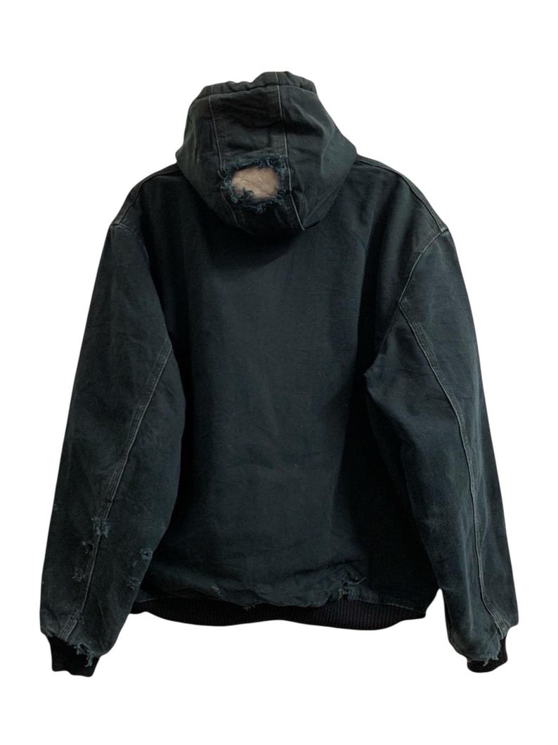 May include: Dark green hooded jacket with distressed details. The jacket features a hood with a hole, ribbed cuffs, and a black bottom hem. The jacket is made of a durable material.