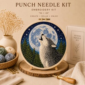 May include: A punch needle embroidery kit featuring a circular wooden hoop with a textured design of a wolf howling at a large, detailed moon above a dark green pine forest. The kit includes a box labelled PUNCH NEEDLE KIT and yarn balls.