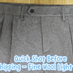 May include: Light grey trousers featuring a waistband with belt loops, a single dark button closure, and vertical pleats on the front. The text "Quick Shot Before Shipping - Fine Wool Light grey" is overlaid on the lower portion of the garment.