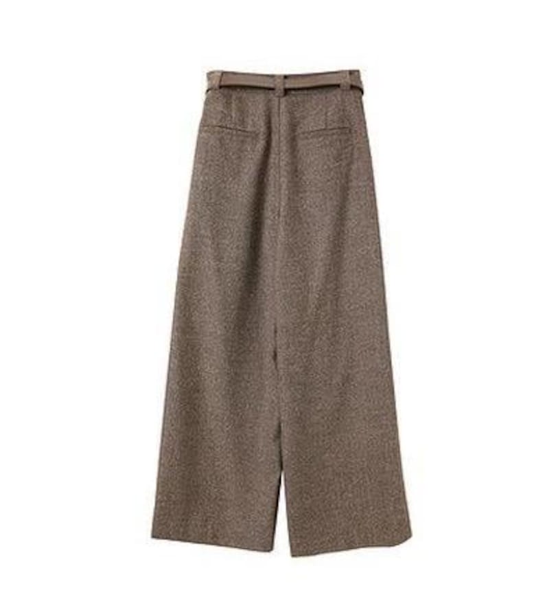 May include: High-waisted wide-leg trousers in a textured brown fabric. These pants feature a matching belt with a buckle at the waist, two horizontal welt pockets on the back, and a straight, loose-fitting silhouette that extends to the hem.