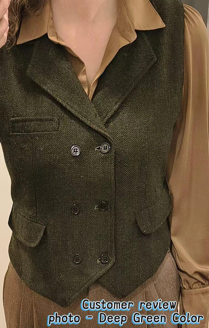May include: A dark green double-breasted vest featuring a herringbone pattern, a notched lapel, and six black buttons. The vest includes two front flap pockets and one chest pocket. The text "Customer review photo - Deep Green Color" is visible.