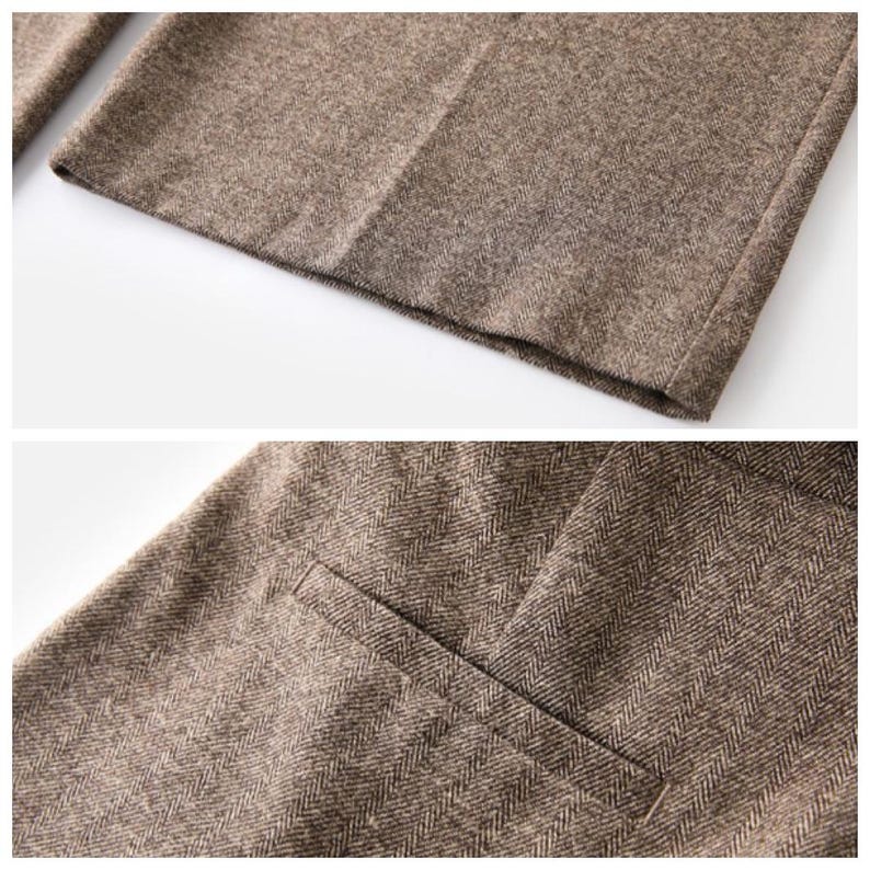 May include: A pair of brown trousers featuring a classic herringbone pattern. The garment includes a straight hemline and a single welt pocket detail on the side, showcasing the textured weave of the fabric in a neutral earth tone.