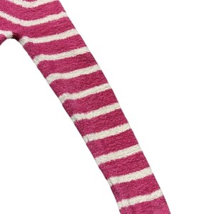 May include: Close-up of a pink and white striped sweater sleeve. The sleeve is made of a soft, fuzzy material. The stripes are horizontal and evenly spaced. The cuff of the sleeve is a solid pink color.