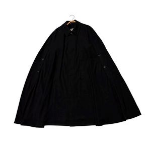 May include: A black cape-style coat with a button-down front and a collar. The coat is hanging on a wooden hanger. The fabric appears to be a medium-weight material, suitable for cooler weather. The coat has a classic, timeless design.