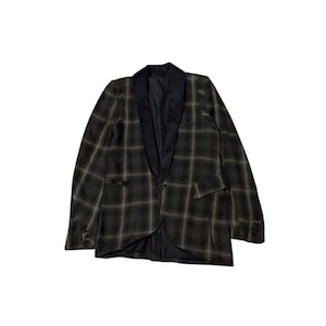 May include: A dark green and black plaid blazer with a black satin lapel. The blazer has a single-button closure and two front pockets. The sleeves have three buttons at the cuff.