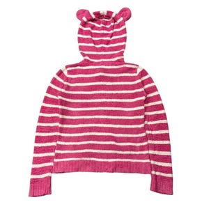 May include: Pink and white striped hooded sweater with bear ears on the hood. The sweater has long sleeves and a ribbed hem and cuffs. The horizontal stripes alternate between pink and white.