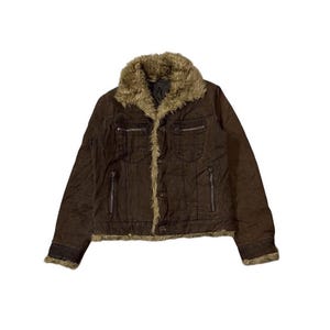 May include: A brown jacket featuring a faux fur collar and trim. It has a button-up front, two chest pockets, and two zipped pockets. The cuffs are trimmed with the same faux fur as the collar.