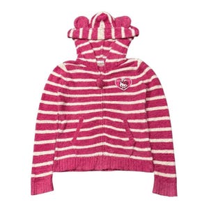 May include: A pink and white striped zip-up hoodie with a hood featuring cat ears. The hoodie has a front pocket and a small emblem on the chest. The design is a cozy, casual style.