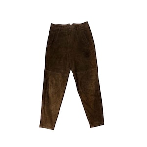 May include: Brown suede pants with a high waist and button closure. The pants have a classic five-pocket design and a relaxed fit. The suede material has a soft, textured appearance.