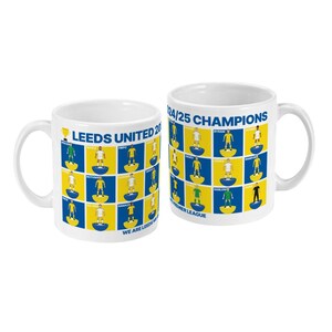 May include: Two white ceramic mugs with a Leeds United 24/25 Champions design. The mugs feature a blue and yellow checkered pattern with player illustrations and text. The mugs have a curved handle.