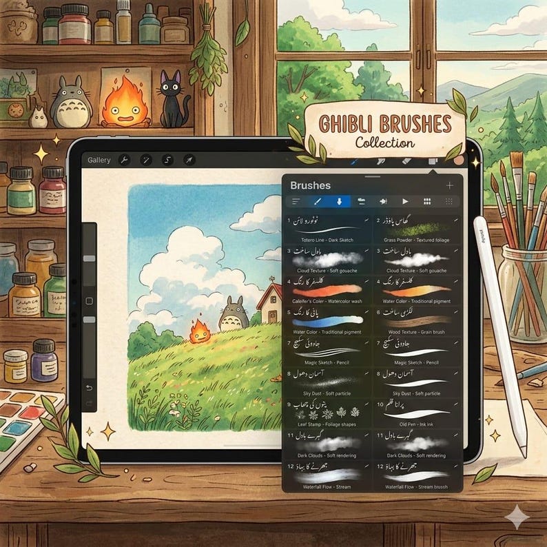 May include: A digital tablet displaying a Ghibli Brushes Collection interface with a brush menu overlay. The screen shows a landscape illustration featuring a grassy hill, clouds, and a small creature. A stylus rests on the wooden desk nearby.