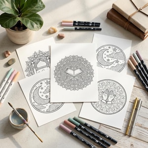 May include: A collection of mandala coloring pages with intricate designs, including a mosque, crescent moon, and open book. Various colored markers and a small watercolor set are arranged around the pages, suggesting a creative activity.