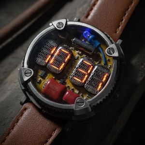 May include: A unique wristwatch with a brown leather band. The watch face displays the time, 10:34, in glowing orange digits. The watch has a silver-colored case and a complex internal mechanism.