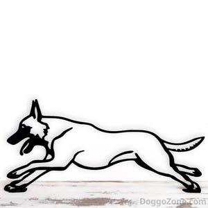 May include: Black and white metal cutout of a running dog. The dog is shown in a dynamic pose, with its legs extended and mouth open. The dog's silhouette is against a white background.