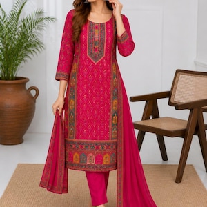 May include: A vibrant fuchsia three-piece ensemble featuring a knee-length tunic with intricate multi-colored geometric patterns along the neckline, cuffs, and hem, paired with matching solid fuchsia trousers and a long, lightweight fuchsia dupatta.
