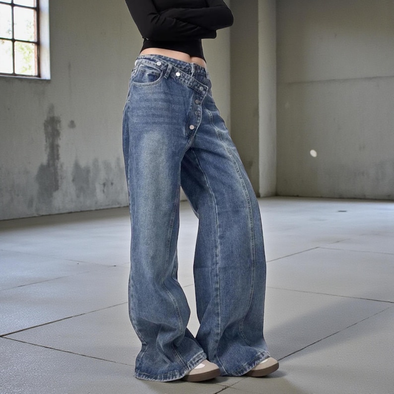 Women's Baggy Button Jeans | Irregular Stacked Pants | Streetwear Y2k Fashion

Wide-leg stacked denim pants with an irregular button fly, styled with a fitted long-sleeve top in a studio setting.