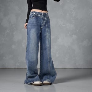 Women's Baggy Button Jeans | Irregular Stacked Pants | Streetwear Y2k Fashion

Wide-leg stacked denim pants with an irregular button fly, styled with a fitted long-sleeve top in a studio setting.