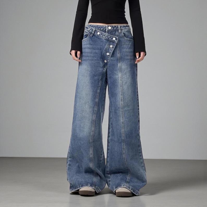 Women's Baggy Button Jeans | Irregular Stacked Pants | Streetwear Y2k Fashion

Wide-leg stacked denim pants with an irregular button fly, styled with a fitted long-sleeve top in a studio setting.