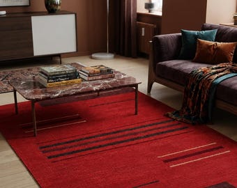 May include: A rectangular area rug featuring a vibrant red base with horizontal black and dark brown stripes. The rug includes thin, light-colored linear accents and a dark brown border at one end with a short, white fringe along the edge.