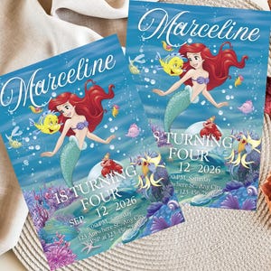 May include: Two invitations featuring a mermaid with red hair, a purple seashell top, and a turquoise tail. The invitations have the name "Marceline" in script and text that reads "1S TURNING FOUR" and the date "SEP 12 2026".