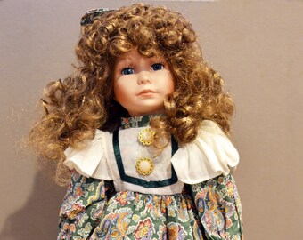 Porcelain Doll With Brown Hair and Paisley Print Dress