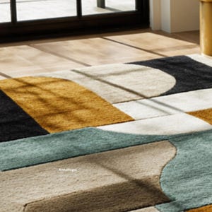 May include: A modern area rug with a geometric design. The rug features a combination of colors, including black, beige, gold, and teal. The design includes curved and rectangular shapes, creating a contemporary look. The rug is made of a soft, textured material.