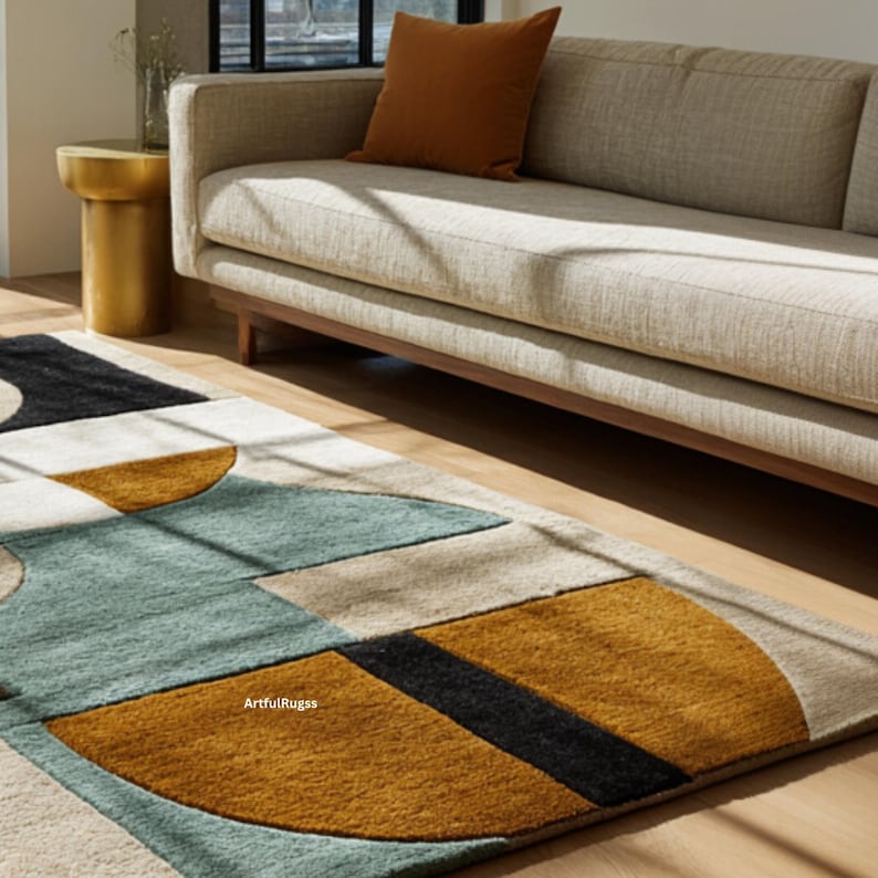 May include: Geometric patterned area rug with a modern design. The rug features a combination of colors including teal, mustard yellow, black, and beige. The rug is placed on a hardwood floor, with a sofa and side table in the background.