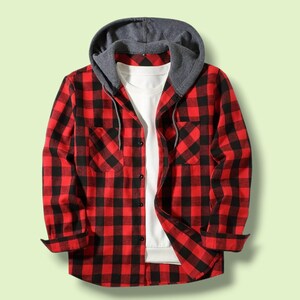 May include: A long-sleeve button-up shirt featuring a red and black buffalo plaid pattern. The shirt includes a gray jersey-knit hood with matching drawstrings and a solid white undershirt layer visible at the center front opening.