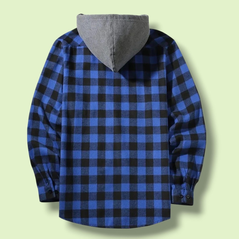 May include: A long-sleeved button-up shirt featuring a blue and black buffalo plaid pattern. The garment includes a solid grey hood attached at the collar, long sleeves with buttoned cuffs, and a straight hemline, shown from the back view.