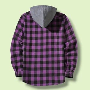 May include: A long-sleeve button-up shirt featuring a purple and black buffalo plaid pattern. The garment includes a solid grey hood attached at the collar, long sleeves with buttoned cuffs, and a straight hemline, shown from the back view.