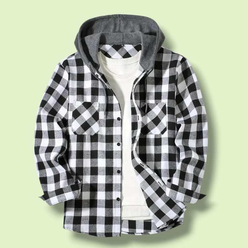 May include: A long-sleeve button-down shirt featuring a black and white buffalo check pattern, two chest pockets, and a solid gray jersey knit hood with matching drawstrings, layered over a plain white crew neck t-shirt.
