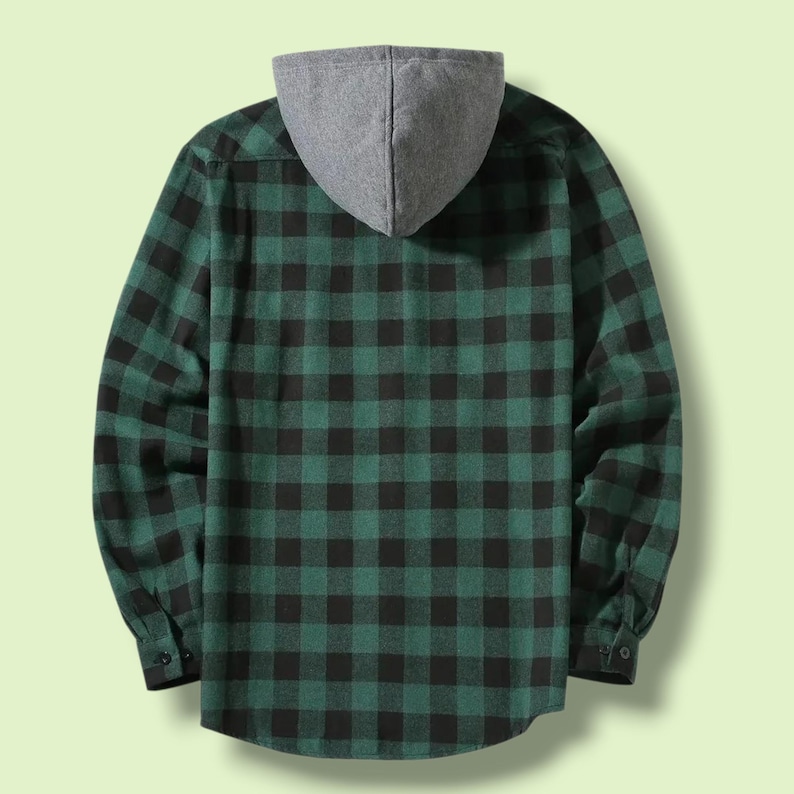 May include: A long-sleeved button-down shirt featuring a dark green and black buffalo plaid pattern. The garment includes a solid heather gray hood attached at the collar, long sleeves with buttoned cuffs, and a straight hemline at the bottom.