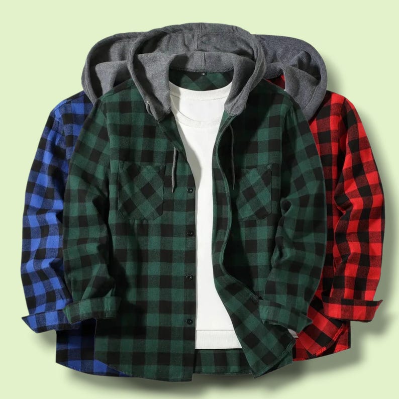 May include: A long-sleeve hooded shirt featuring a green and black buffalo plaid pattern, a gray jersey hood with drawstrings, a front button closure, and a chest pocket, layered over a plain white t-shirt, with blue and red plaid versions visible.