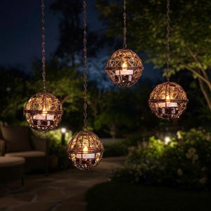 May include: Four hanging spherical candle lanterns with a geometric metal cage design. Each lantern holds a lit candle, casting a warm glow. The lanterns are suspended by chains, creating a decorative outdoor lighting display.