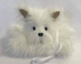 May include: A plush white dog with a fluffy coat, black eyes, and a black nose. The dog has tan ears and a white ribbon tied around its neck. The toy is designed to resemble a West Highland White Terrier.