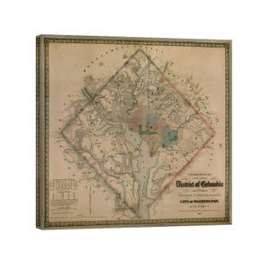 May include: An antique map of the District of Columbia and the City of Washington, framed in a decorative border. The map features detailed cartography with color-coded areas and text, showcasing the historical layout of the city.