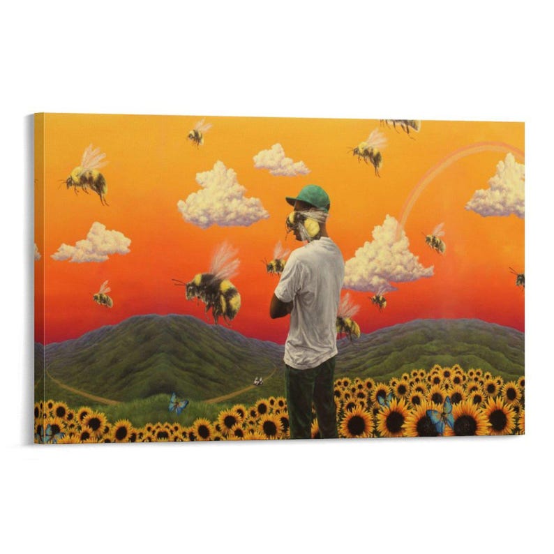 May include: A canvas print featuring a surreal landscape with a person standing in a field of sunflowers. The artwork includes bees, clouds, a rainbow, and a vibrant orange and yellow sky. The person is wearing a green cap and white shirt.