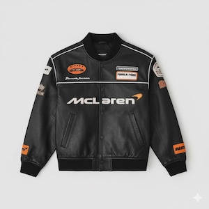 May include: Black leather jacket featuring the McLaren logo and multiple patches. The jacket has a black ribbed collar, cuffs, and hem. White stripes run down the sleeves and across the chest. Patches include the text "PUREGOODSPAIN FORMULA 1 PADDOCK".