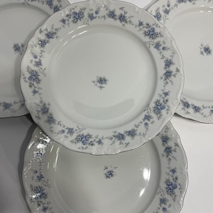 May include: A set of three ceramic mugs with a speckled, matte finish. The mugs are in shades of cream, light gray, and dark gray. Each mug has a simple, minimalist design, perfect for coffee or tea.