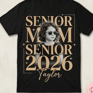 May include: Black t-shirt with a photo of a person wearing sunglasses, with the words "SENIOR MOM SENIOR 2026 Taylor" in gold lettering. The design includes stars and a gold border.