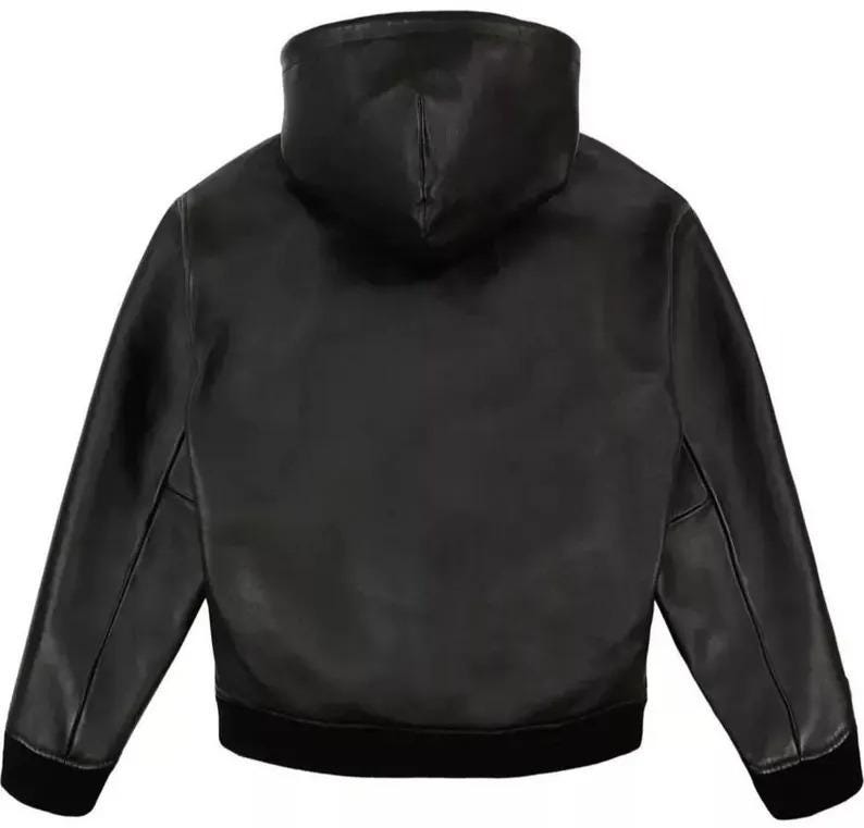 Pu&ograve; includere: Giacca in pelle nera con cappuccio. La giacca ha orlo e polsini a coste. Il cappuccio &egrave; attaccato alla giacca ed &egrave; realizzato nello stesso materiale in pelle nera. La giacca &egrave; in stile bomber.