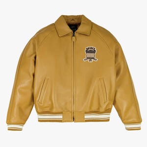May include: Mustard yellow leather bomber jacket with a zip-up front, side pockets, and a ribbed hem and cuffs with white stripes. Features a patch on the chest with the text "AVIREX" and a patriotic design.