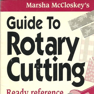 May include: Book cover for "Guide To Rotary Cutting" by Marsha McCloskey. The cover features the title in large black letters, with the subtitle "Ready reference for cutting patchwork pieces without templates." Includes illustrations of fabric pieces and a rotary cutter.
