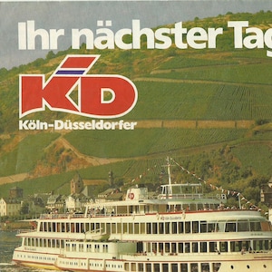 May include: A promotional image for KD Cologne-Dusseldorf, featuring a large white passenger ship sailing on a river. The background includes a castle, green hills, and the text "Ihr nächster Tag Urlaub". A small graphic shows a cartoon character.