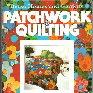May include: A book cover for "Better Homes and Gardens Patchwork & Quilting." The cover features a colorful floral design with the title in large white letters. The book's interior shows a patchwork quilt with green pillows.