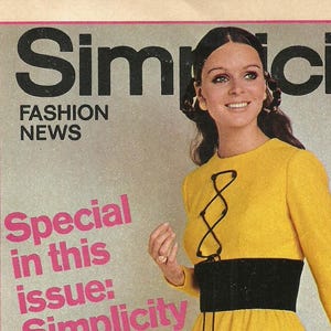May include: Vintage Simplicity Fashion News magazine cover. The cover features a woman in a yellow dress with a black waist band and black detailing. The magazine's title is "Simplicity" with the text "Fashion News". Additional text includes "Special in this issue" and "Spring's prettiest dresses".