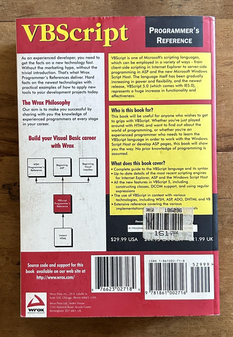 May include: A red and yellow paperback book titled VBScript Programmer's Reference. The back cover features text describing the Wrox philosophy, target audience, and book contents, along with a barcode, ISBN 1-861002-71-8, and a price sticker.