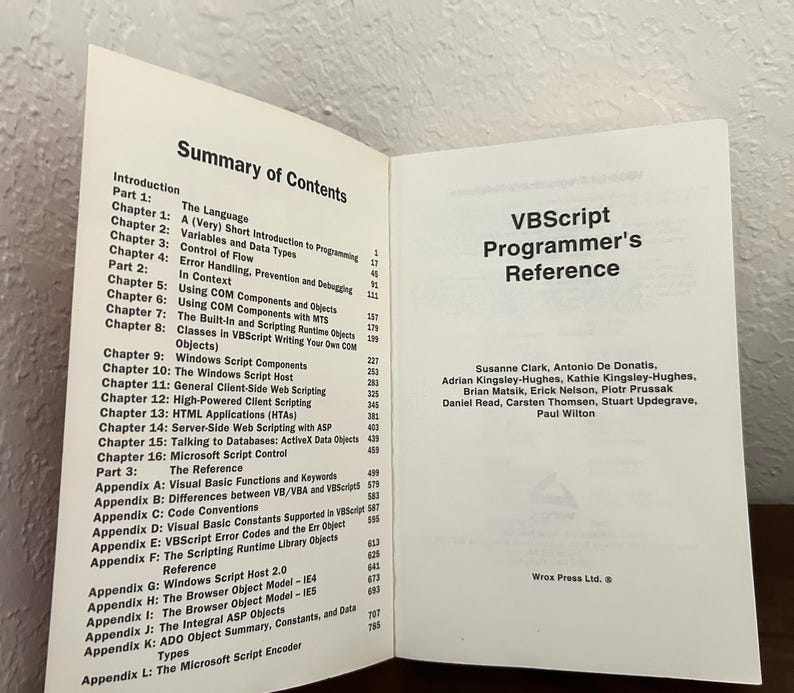 May include: An open book titled VBScript Programmer's Reference with black text on white pages. The left page displays a Summary of Contents listing chapters and appendices. The right page lists the authors and the Wrox Press Ltd. logo.