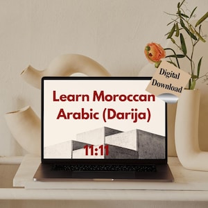 以下が含まれることがあります： 「Learn Moroccan Arabic (Darija)」と「11:11」が表示されたノートパソコン。 「Digital Download」のタグが花瓶に付けられています。 ノートパソコンは白い棚の上にあり、装飾的な花瓶が置かれています。